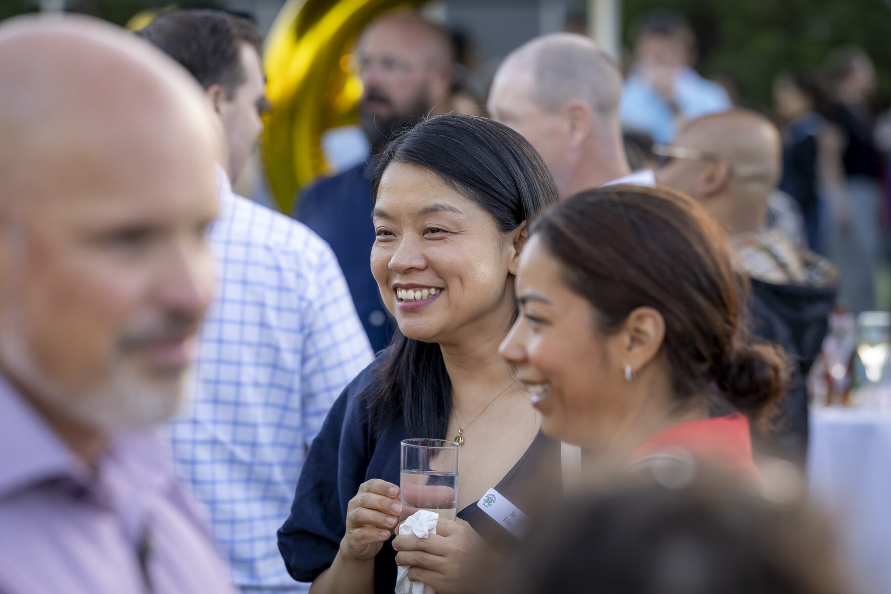 Trinity parents smiling and talking together at a school community event